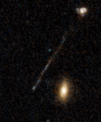 Autor: NASA, ESA, Pieter van Dokkum (Yale); Image Processing: Joseph DePasquale (STScI) - Tento archivní snímek Hubbleova vesmírného dalekohledu zachycuje zvláštní lineární útvar, který tvoří 200 000 světelných let dlouhý řetězec mladých modrých hvězd. Na špičce mostu vlevo dole se nachází supermasivní černá díra. Pozorujeme útvar v době, kdy byl vesmír přibližně v polovině svého současného stáří.