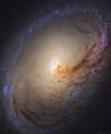 Autor: ESA/NASA/Hubble (Leo Schatz) - Snímek galaxie M96 s výrazným prachovým pásem v centru