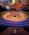 Autor: Jose-Luis Olivares and Dheeraj Pasham, MIT - Umělecká představa průchodu menší černé díry o hmotnosti sto až deset tisíc hmotností Slunce akrečním diskem rotujícím kolem centrální supermasivní černé díry. Při každém průchodu je nad disk vyvržen chuchvalec plynu, který částečně zablokuje záření akrečního disku pod ním a způsobí krátkodobý pokles intenzity rentgenového záření.