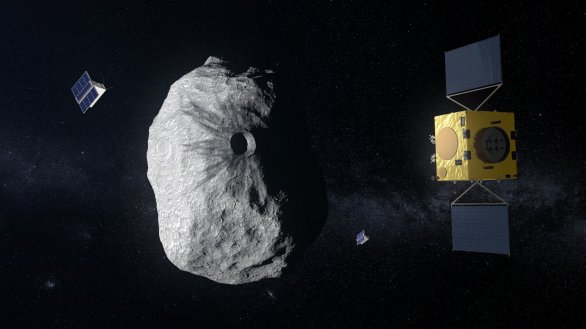 Sonda Hera a její dva doprovodné cubesaty zkoumají na umělecké ilustraci měsíc Dimorphos, do něhož předtím narazila sonda DART. Autor: ESA